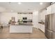 Spacious kitchen features large island, stainless steel appliances, and modern white cabinetry at 531 S 198Th Ave, Buckeye, AZ 85326