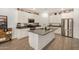 Modern kitchen boasts a large island, stainless steel appliances, and sleek gray countertops at 531 S 198Th Ave, Buckeye, AZ 85326