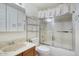 Bright bathroom features a shower-tub combo with sliding doors and a vanity with updated faucet at 5807 W Acoma Dr, Glendale, AZ 85306