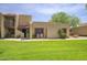 Inviting home featuring a well-manicured lawn and charming architectural details on a sunny day at 5807 W Acoma Dr, Glendale, AZ 85306