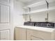 Convenient laundry room includes a side by side washer and dryer hook up and shelving at 5807 W Acoma Dr, Glendale, AZ 85306