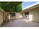 Private patio area with mature trees and brick pavers offering a serene outdoor space at 5807 W Acoma Dr, Glendale, AZ 85306