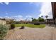 Beautiful backyard with lush lawn, mature trees, and a brick patio area, ideal for outdoor activities at 6027 E Spring Rd, Scottsdale, AZ 85254
