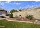 Landscaped backyard featuring a bird bath, flowering bushes, and a well-maintained lawn at 6027 E Spring Rd, Scottsdale, AZ 85254