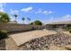 Fenced pool area with a patio and rock landscaping, providing privacy and a resort-like atmosphere at 6027 E Spring Rd, Scottsdale, AZ 85254