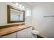 Traditional bathroom features a decorative mirror, marble countertop, and white cabinets at 6027 E Spring Rd, Scottsdale, AZ 85254