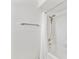 Clean bathroom with white tile and tub/shower combination, and a chrome shower head at 6027 E Spring Rd, Scottsdale, AZ 85254