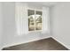 Well-lit bedroom with window and backyard view and hardwood style floor at 6027 E Spring Rd, Scottsdale, AZ 85254