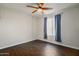 Bright bedroom features hardwood floors, a ceiling fan, and a window providing natural light at 6027 E Spring Rd, Scottsdale, AZ 85254