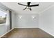 Serene bedroom with wood-look flooring, a ceiling fan, and modern wall sconces at 6027 E Spring Rd, Scottsdale, AZ 85254
