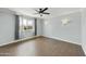 Light-filled bedroom with hard surface floors, wall sconces, and a ceiling fan at 6027 E Spring Rd, Scottsdale, AZ 85254