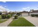 Charming single-story home with manicured lawn, mature trees, and a paved walkway leading to the front door at 6027 E Spring Rd, Scottsdale, AZ 85254