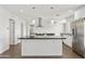 Modern kitchen features a large island, stainless steel appliances, and ample cabinet space at 6027 E Spring Rd, Scottsdale, AZ 85254