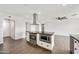 Kitchen featuring stainless steel appliances, sleek black countertops, white cabinets, and seamless integration with adjacent spaces at 6027 E Spring Rd, Scottsdale, AZ 85254