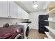 Functional laundry room with storage cabinets, washer, dryer and utility sink at 6027 E Spring Rd, Scottsdale, AZ 85254