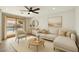 Bright living room with neutral decor and a sliding door to the outdoor pool area at 6027 E Spring Rd, Scottsdale, AZ 85254