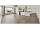 Bright, open living space featuring wood floors, a modern kitchen, and a large window with backyard views at 6027 E Spring Rd, Scottsdale, AZ 85254
