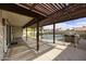 Covered patio with a view of the pool and outdoor kitchen area, perfect for entertaining at 6027 E Spring Rd, Scottsdale, AZ 85254