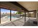 Covered patio overlooking a fenced pool area with an outdoor kitchen, perfect for leisure and entertainment at 6027 E Spring Rd, Scottsdale, AZ 85254