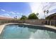 Sparkling pool with an outdoor grilling area and desert landscaping at 6027 E Spring Rd, Scottsdale, AZ 85254