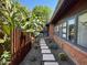 Landscaped backyard with a walkway and verdant tropical foliage alongside the home at 712 W Vernon Ave, Phoenix, AZ 85007
