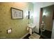 Charming bathroom with decorative wallpaper, framed art, unique sink fixture, and glass shower at 712 W Vernon Ave, Phoenix, AZ 85007