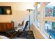 Cozy bedroom featuring a mid-century modern dresser, sleek chair, and backyard views at 712 W Vernon Ave, Phoenix, AZ 85007
