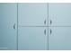 Stylish light blue cabinets with brushed steel hardware offer ample storage space throughout the home at 712 W Vernon Ave, Phoenix, AZ 85007