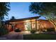 Stunning mid-century modern home with brick exterior, spacious carport, and manicured landscaping at 712 W Vernon Ave, Phoenix, AZ 85007