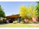 Charming home with lush landscaping, carport, brick facade and a vibrant yellow tree at 712 W Vernon Ave, Phoenix, AZ 85007