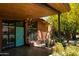 Inviting front entrance features a vibrant blue door, brick accents, and lush landscaping at 712 W Vernon Ave, Phoenix, AZ 85007