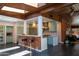 Open-concept kitchen with stainless steel appliances, brick accents, skylights, and eat-in bar at 712 W Vernon Ave, Phoenix, AZ 85007