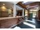Modern kitchen with breakfast bar, brick accents, stainless steel appliances, and bright natural light at 712 W Vernon Ave, Phoenix, AZ 85007