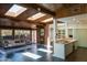 Open-concept living room featuring skylights, brick accents, and an adjacent modern kitchen space at 712 W Vernon Ave, Phoenix, AZ 85007