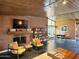 Spacious living room featuring a brick fireplace, tiled floor, and large windows providing plenty of light at 712 W Vernon Ave, Phoenix, AZ 85007