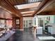 Bright and open living room featuring a skylight, brick accents, and seamless transition to the modern kitchen at 712 W Vernon Ave, Phoenix, AZ 85007