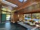 Inviting living room with modern decor, a brick accent wall, and an abundance of natural light from the skylights at 712 W Vernon Ave, Phoenix, AZ 85007