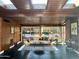 Comfortable living room with stylish furniture, exposed brick and wood, and natural light from large windows at 712 W Vernon Ave, Phoenix, AZ 85007