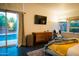 Bright main bedroom with a view of the pool, sleek dresser, and painted brick accent wall at 712 W Vernon Ave, Phoenix, AZ 85007