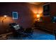 Comfortable office with brick walls, a vintage desk, and a lounge chair with ottoman at 712 W Vernon Ave, Phoenix, AZ 85007