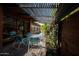 Charming outdoor patio with seating, lush greenery, and a pergola providing shade at 712 W Vernon Ave, Phoenix, AZ 85007