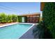 Relaxing pool area with a covered patio, lush greenery, and a serene atmosphere at 712 W Vernon Ave, Phoenix, AZ 85007
