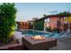 Backyard pool with a fire pit, lounge chairs, and a covered patio, perfect for outdoor entertaining at 712 W Vernon Ave, Phoenix, AZ 85007
