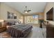 The main bedroom boasts a serene ambiance, with views of the backyard pool and modern décor at 7332 W Pershing Ave, Peoria, AZ 85381