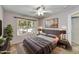 Bright bedroom with a large window, neutral tones, and modern decor creates a comfortable and inviting space at 7332 W Pershing Ave, Peoria, AZ 85381