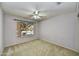 Cozy bedroom with carpet, a ceiling fan, and a large window at 7332 W Pershing Ave, Peoria, AZ 85381