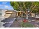 Charming single-story home featuring desert landscaping and a mature shade tree in the front yard at 7332 W Pershing Ave, Peoria, AZ 85381