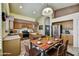 Inviting kitchen with wood cabinets, stainless steel appliances, island and a connecting dining area at 7332 W Pershing Ave, Peoria, AZ 85381