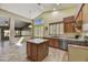 Bright kitchen featuring an island, stainless steel appliances, and natural wood cabinetry at 7332 W Pershing Ave, Peoria, AZ 85381