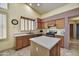 Spacious kitchen with an island, stainless steel appliances, and warm-toned wood cabinets at 7332 W Pershing Ave, Peoria, AZ 85381